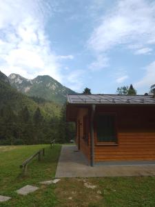 a log cabin with mountains in the background at Orsera in Cesiomaggiore +1 photo