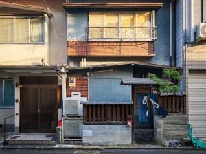 an apartment building with a door and a balcony at 青鵺 Aoya Private entire House near the Nijo castle in Kyoto