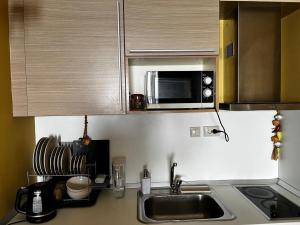 a kitchen with a sink and a microwave at Sirena apartament First Line in Golden Sands