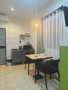 a kitchen with a table and a stove at Cozy House blue in Fisherman's village in Bophut 