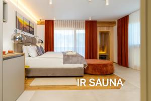 a bedroom with a king sized bed and red curtains at Landhouse Bled in Selo pri Bledu