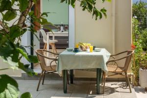 a table and chairs on a patio with a table and drinks at Τhe fisherman's house in Sami