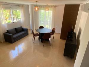 a living room with a table and chairs and a couch at Duplex Deluxe in Torreblanca