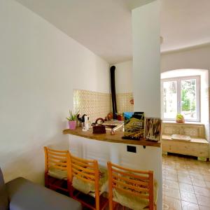 a kitchen with a counter and a table and chairs at El Me Popo in Segonzano +18 photos