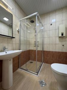 a bathroom with a glass shower and a sink at Apartment CityHeart in Ohrid +28 photos