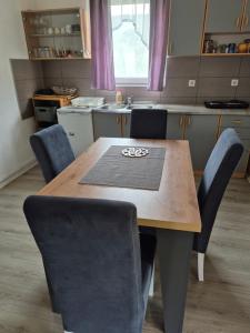 a kitchen with a wooden table and chairs at Un Rio Sana in Gornji Ribnik