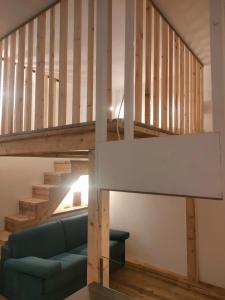 a living room with a blue couch under a staircase at Prealba 2 in Levanto
