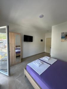 a bedroom with two beds and a mirror at Apart Hotel White Pearl in Bar