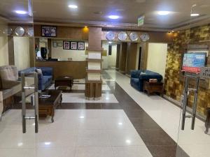 a lobby with couches and a staircase in a building at Siveen Hotel in Amman