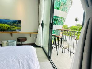 a bedroom with a bed and a balcony at 303MSNK Luxe Spacious Studio l Balcony in Can Tho