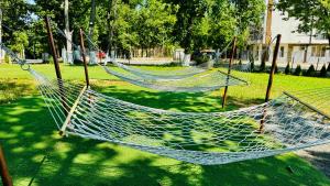 a couple of hammocks in a park at Hotel Neva in Kiten +60 photos