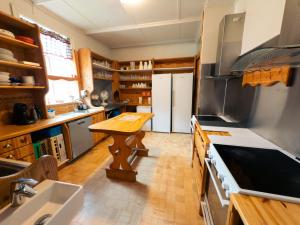 a kitchen with a wooden table in the middle of it at Asgardur Glamping in Hvolsvöllur