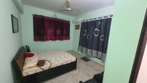 a bedroom with a bed and a ceiling fan at Moments - peaceful moments among nature and green surroundings in Shāhāpur