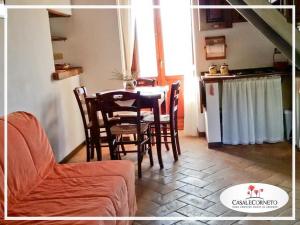 a living room with a table and chairs and a kitchen at Pallano in Bomba