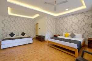 a bedroom with two beds and a tv in it at Budget Friendly Home Stay at CALANGUTE G0A in Candolim +7 photos
