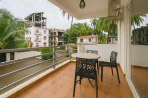 a balcony with a table and two chairs on it at Budget Friendly Home Stay at CALANGUTE G0A in Candolim
