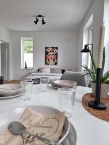a dining room with a table with plates and glasses at 1-Zimmer-Loft Casa Frida in Walldürn