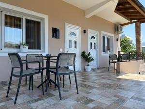 a patio with chairs and a table on a porch at Vila Roan in Vlorë