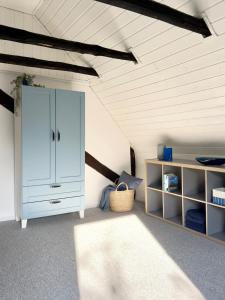 a bedroom with a large white cabinet and a rug at Alte Dorfschmiede - idyllische Ferienwohnung in Meschede-Calle in Meschede