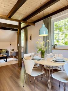 a dining room with a table and chairs at Alte Dorfschmiede - idyllische Ferienwohnung in Meschede-Calle in Meschede