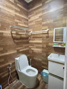 a bathroom with a toilet and a sink at Amdel Home in Kampung Raja