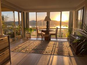 a living room with a table and chairs and a view at Riverside Retreat in Karuah
