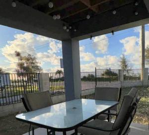 a glass table and chairs on a patio at Lulu's beachouse in Nuku‘alofa