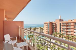 a balcony with chairs and a view of the ocean at Hotel Best Roquetas in Roquetas de Mar