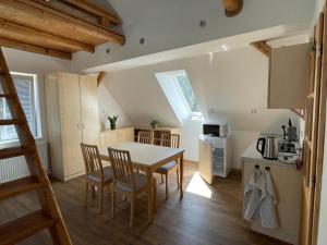 a kitchen and dining room with a table and chairs at Apartmány pod Jizerkami in Weissbach