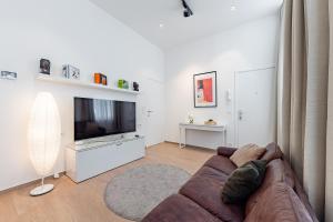 a living room with a couch and a flat screen tv at Fully furnished and modern flat - Brussels center in Brussels
