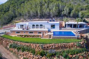 an aerial view of a house with a stone wall at Villa Morna Valley in Sant Joan de Labritja