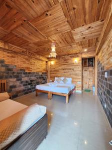 a bedroom with a bed and a wooden ceiling at Sneh by Daisey in Cheog