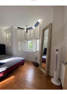 a bedroom with a large bed and a mirror at 600sf 1 bedroom apartment in Moffat
