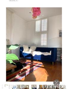 a living room with a blue couch and a window at 600sf 1 bedroom apartment in Moffat