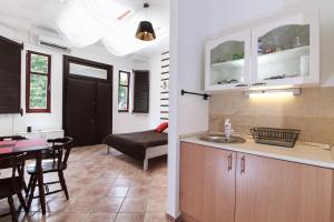 a kitchen and a living room with a table at Ecoappartment in Mosonmagyaróvár +13 photos