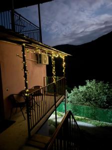 a patio with lights on the side of a house at Goshniver Rest House in Dilijan