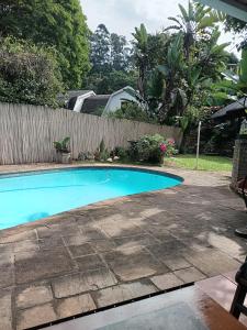 a swimming pool in a yard next to a fence at Apartment-double storey-2 bedrooms-own bathroom, kitchen, dining room, entrance, lounge, patio in Pinetown +23 photos