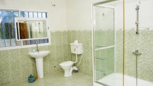 a bathroom with a toilet and a sink and a shower at MB Properties - Sinchu Alagie in Madina Sey Kunda +19 photos