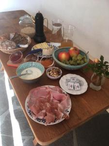 a wooden table topped with different types of food at Knappnhof in Campo di Trens