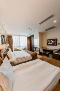 a hotel room with two beds and a flat screen tv at Hotel Diamond in Baku +68 photos