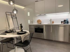 a kitchen with a table and chairs and a table and a counter at The City Nest Apartment 38A in Delft