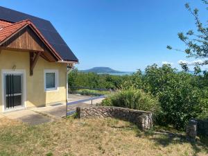 a house with a solar panel on the roof at Seasons & Connections in Balatongyörök
