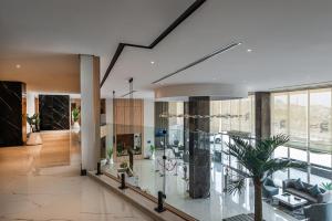a living room with a large glass wall at Rhenium Hotel Abha in Abha