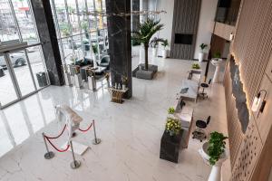 an overhead view of a lobby with tables and chairs at Rhenium Hotel Abha in Abha