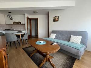 a living room with a couch and a table at Paradiso 5 in Bratunac