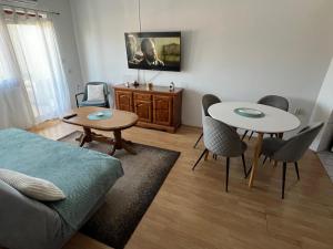 a living room with two tables and a couch at Paradiso 5 in Bratunac