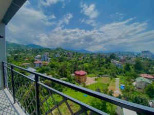 a balcony with a view of a city at Green House - Apartment with Separate Room and Sea View in Batumi