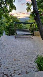 a park bench sitting on top of a stone patio at Nurnus rest zone in Byureghavan