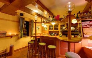 a bar in a restaurant with stools at a counter at Gemündener Hof in Gemünden