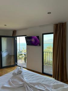 a bedroom with a bed with a view of the ocean at Lake Escape Villa Shirokë in Shkodër